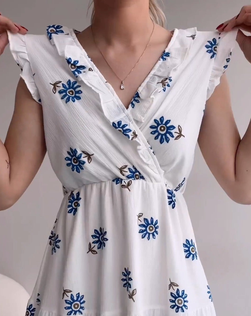 White sleeveless blue flower dress